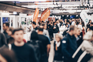 Abstract blurred people at exhibition hall of expo event trade show. Business convention show or...
