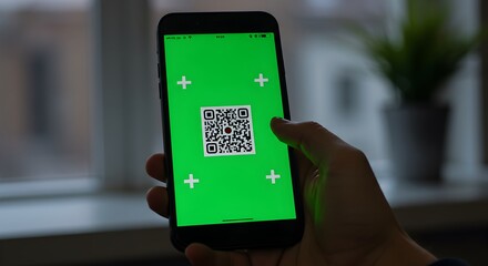 Close-up of mobile phone with green screen and tracking markers in hand