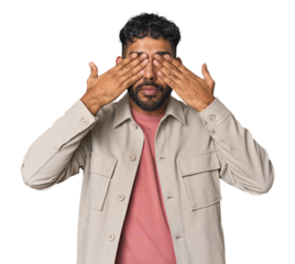 Young Hispanic man isolated afraid covering eyes with hands.