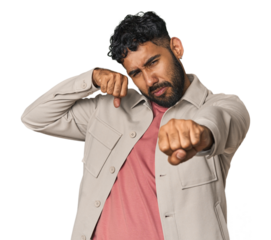 Young Hispanic man isolated throwing a punch, anger, fighting due to an argument, boxing.