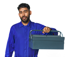 Young Hispanic male mechanic holding a toolbox in studio