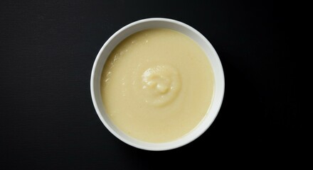 Creamy Soup in White Bowl on Dark Background