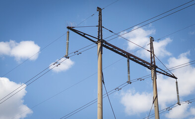 Poles with high voltage wires against the blue sky 3