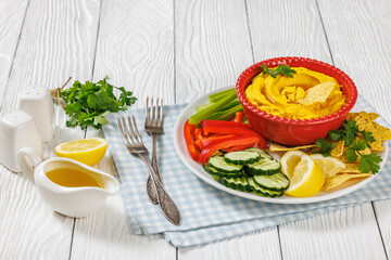creamy roast carrot hummus in red bowl