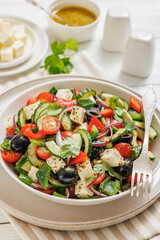 greek salad of veggies, olives, cheese in bowl
