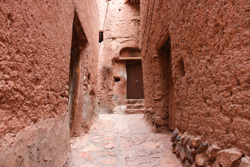 ancient ruins of the ancient city of Abyaneh, Ancient village, Peaceful alley, Abyaneh village, Cloudy sky, Narrow alley leading to a blue sky, Ancient village under a cloudy sky, Iran, Persia