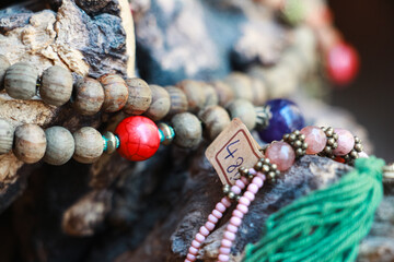 wood bead necklace, jewelry on stone background, Wooden bead necklace on stone, Colorful boho...