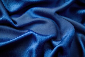 Fototapeta premium Draped deep blue satin fabric with subtle texture and rich color.