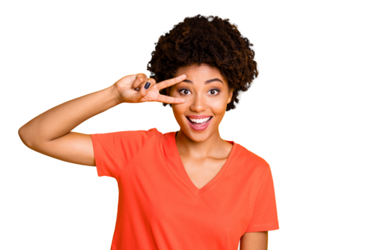 Photo of nice charming fascinating attractive afro americal girlfriend showing you v-sign with something wearing t-shirt smiling toothily isolated over yellow vivid color background