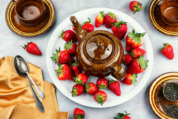 Strawberry tea with fresh strawberries.