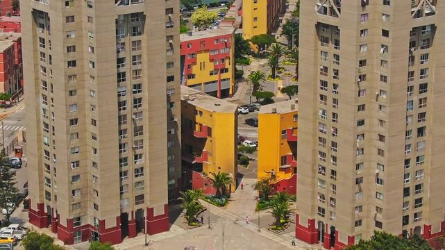 Aerial: Torres de Limatambo during the day with buildings in San Borja District, Lima, Peru, crane up drone shot