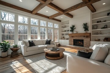Fototapeta premium Spacious modern farmhouse living room with white oak floors, fireplace, and built-in shelves. Bright walls, light wood beams, and wide-open space.