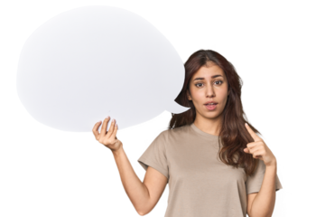 Middle Eastern woman holding comic bubble pointing upside with opened mouth.