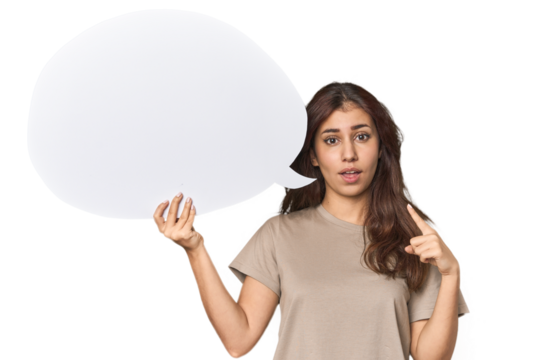 Middle Eastern woman holding comic bubble pointing upside with opened mouth.