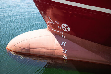 A large red ship with a propeller on the side