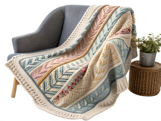 A cozy knitted blanket drapes elegantly over a stylish armchair, showcasing intricate textures and warm hues of blue, pink, and cream. The blanket adds a touch of comfort PNG transparent