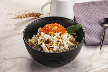 Curd with granola and orange jam