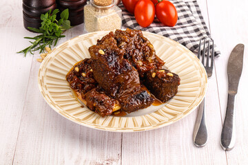 Prepared tasty beef ribs with sauce