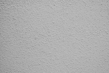 Textured gray wall with subtle patterns creates a modern backdrop for design