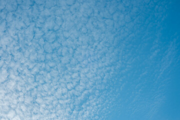 Beautiful cloud patterns in a clear blue sky on a sunny day