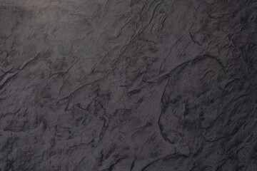 Naklejka premium Dark textured surface showcasing natural stone-like patterns and shades