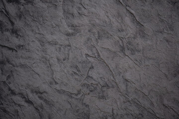 Grey textured surface showcasing intricate rock patterns in natural lighting