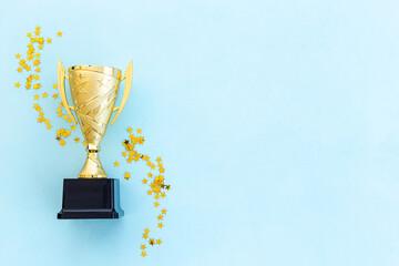 Award victory trophy cup with golden stars, top view. Success and victory concept