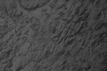 Detailed texture of dark slate rock showing intricate patterns and lines