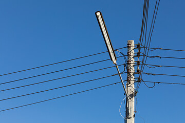 power lines and communication lines on electric poles with the blue sky