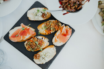 Gourmet appetizers displayed beautifully on a serving board at a dining event