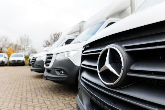 Barleben, Germany - Nov 14th, 2024: Fleet new modern electric hybrid  or diesel Mercedes Sprinter vans parked in line row outdoors. Cargo freight industrial courier transportation logistics service