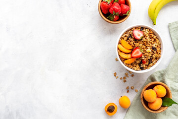 Top view of breakfast with oatmeal granola and ingredients. Healthy morning routine