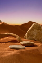 Round pebbles laid on the sand. Triangular boulders showing rough surface with light veins and...