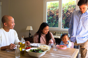 Family friend observing family during mealtime