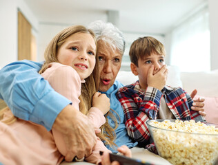television watching tv home elderly senior grandmother fun family granddaughter  together grandson...