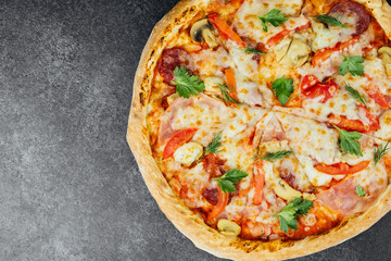 Delicious pizza topped with fresh ingredients on a dark background