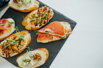 Delicious appetizers served on a slate platter with fresh ingredients