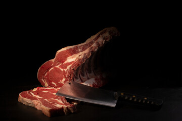 Butcher cutting loin on black background