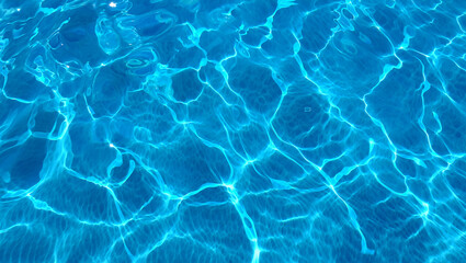 Blue water with ripples on the surface. Defocus blurred transparent blue colored clear calm water surface texture with splashes and bubbles.