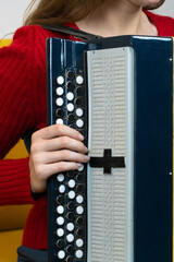 Close-up of a musician's hands playing a traditional russian bayan accordion, pressing the keys and...