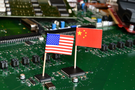 Flag of the Republic of China and the United States on microchips of a printed electronic board. Concept for world supremacy in microchip and semiconductor manufacturing.