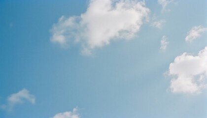 Fototapeta premium Celestial Canvas: Capturing the vast expanse of the bright blue sky, adorned with fluffy white clouds, creating a sense of tranquility and serenity. 