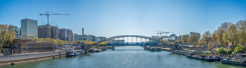 Paris, France - 04 05 2025: Panoramic view of Austerlitz Bridge with a passing tram from Sully Bridge.