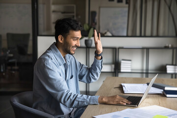 Indian businessman engaged in virtual communication and elearning at online conference or remote...