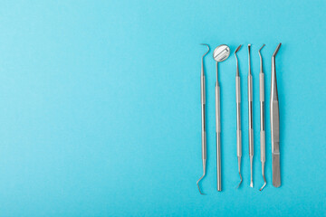 Dentist tools on a blue background. Dentist Concept.Teethcare, dental health concept. Means to care for the oral cavity. Dental model and dental equipment. Dental hygiene. Space for text. Copy space.