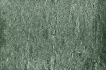 Green textured background showing rough surface with cracks and scratches