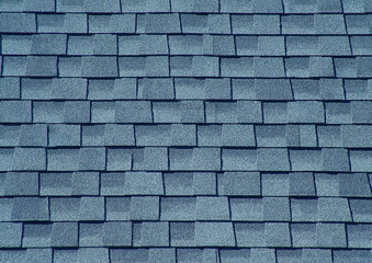Modern asphalt shingles covering a roof creating a textured pattern