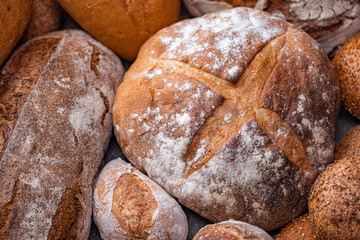 Freshly baked natural bread is on the kitchen table.