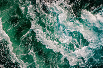 Blue waves of water of the river and the sea meet each other during high tide and low tide.
