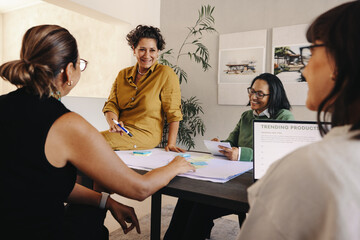 Professional women collaborating during a meeting in a modern office space